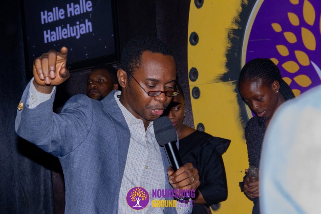 Pastor Temiloluwa Ola Ministering on the altar in church